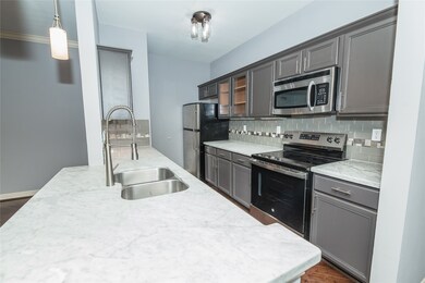Updated kitchen features marble countertops.