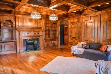 Gather in the family room with hardwood floors, stain glass accents, wood grid ceiling and a decorative fireplace framed by built-ins.