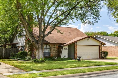 View of front facade featuring a garage and a front yard