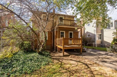 Back of property with a balcony