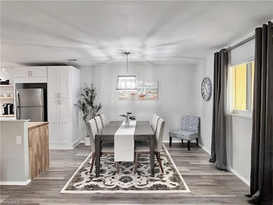 Dining space featuring light wood-style floors and baseboards