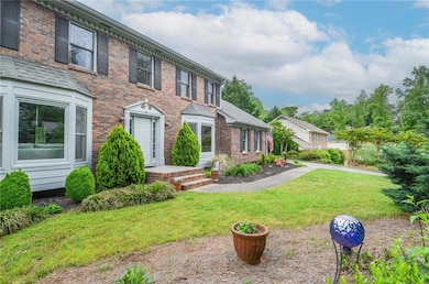 View of front of house featuring a front yard and brick siding