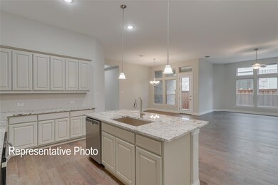 Kitchen with hanging light fixtures, a healthy amount of sunlight, sink, and stainless steel dishwasher