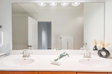 Bathroom featuring ornamental molding and double 