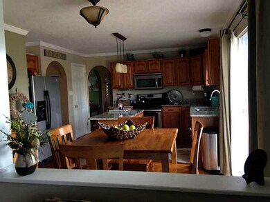 Kitchen. View of kitchen from living room. On the right is the doorway to the deck.
