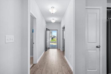 Corridor featuring hardwood / wood-style flooring