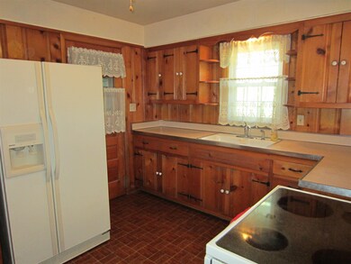 The Kitchen has quaint knotty pine cabinets.