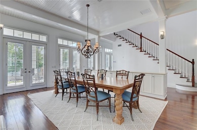 Dining area with french doors, beamed ceiling, har