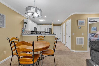 Dining room with visible vents, light colored carpet, and crown molding