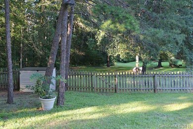 Partially fenced yard.  Yard extends past fence to