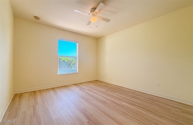 Unfurnished room featuring light wood-type flooring and ceiling fan