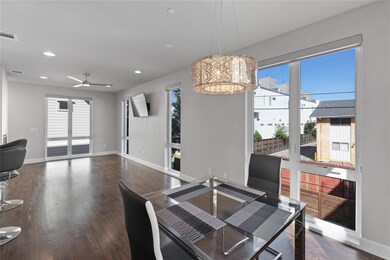 Dining space with ceiling fan with notable chandel