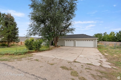 View of front facade featuring concrete driveway and a garage