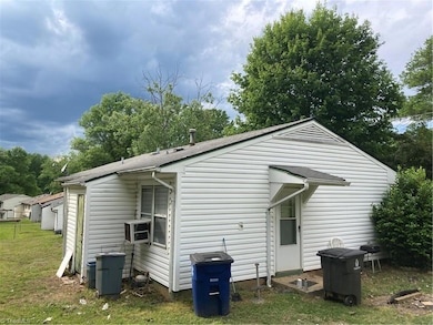 Moving around the house to the left (all directions are when viewed from the street) shows a window AC unit, despite house having central heat & cooling.  That likely means the AC unit needs servicing.