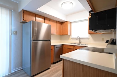 Kitchen featuring stainless steel appliances, lig