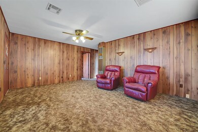 Living room featuring ceiling fan, a wall mounted 