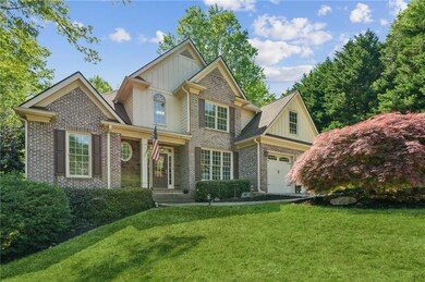 Craftsman-style home featuring a front lawn, brick