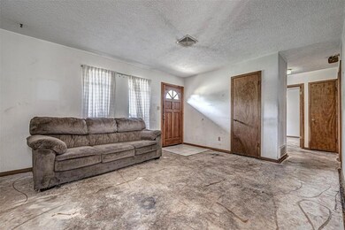 Living room with tile floors and a textured ceilin