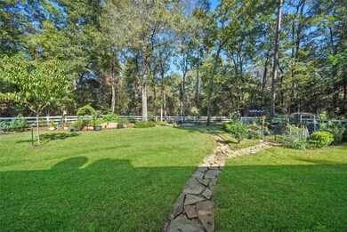 1/3 +/- Acre of majestic trees outside the fence -Beautiful back yard with arbors, peach tree & many gorgeous bloomers including pink roses. The garden path goes out to the back fence. Sellers have left a portion wooded well beyond the required 20 ft. The back neighbor's fence is NOT the property line (not visible). Back neighbor has also left the required 20 ft of wooded portion unfenced on the left corner that expands to about 60 ft at the right corner - sort of a wedge as their lot is not straignt.