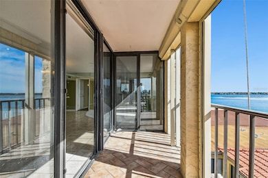 Balcony with waterfront view and hurricane shutters
