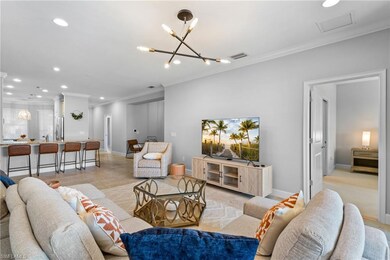 Living area with ornamental molding, a chandelier,