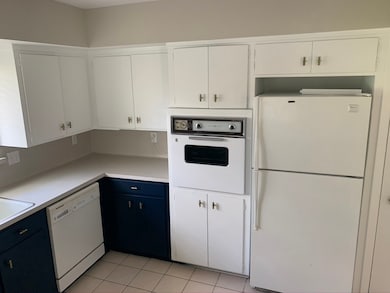 Kitchen is light and bright with navy blue bottom