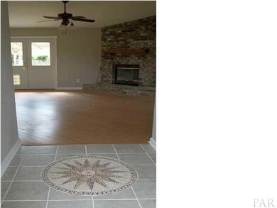 Entry way with tile design. Kitchen to left. Bedrooms to right.