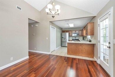 Dining Area with Kitchen and Hall Leading to the L