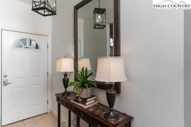 The foyer with ceramic tile floor has a handsome t