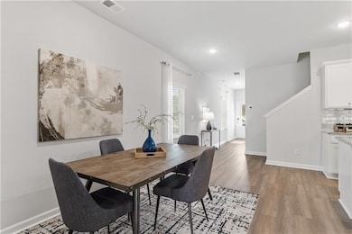 Dining space with light wood finished floors, base