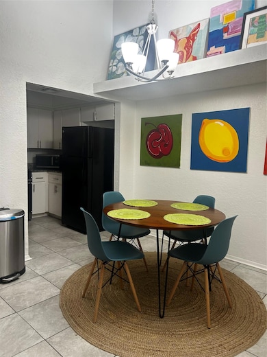 Dining area featuring light tile patterned floori