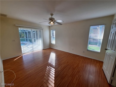 Empty room with a ceiling fan, wood finished floor
