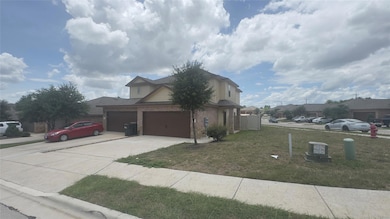 View of side of home featuring brick siding, driv