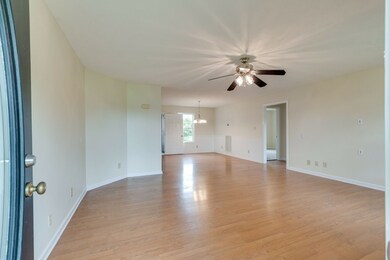 Opening the front door, the living room has laminate hardwood with view of dining room