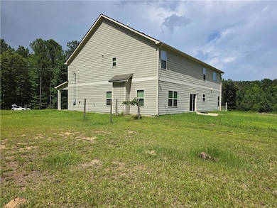 Back of house with a lawn
