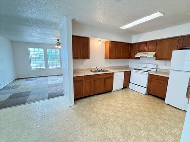 Kitchen featuring white appliances, under cabinet