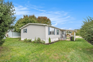 View of side of home with a yard