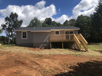 Back view of the house featuring a large deck 