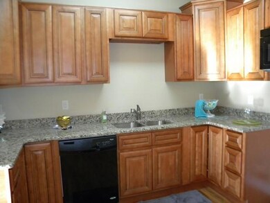 Beautiful kitchen with granite counter tops, custom cabinets, and lots of work space