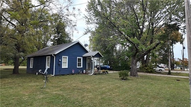 View of side of property featuring a lawn