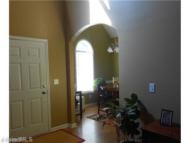 Dining Room. Notice the arched doorway and the laminate flooring as you enter into the home.
