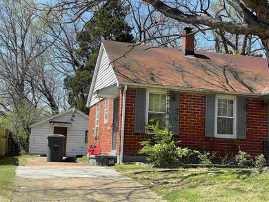 View of side of property with brick siding, a chim