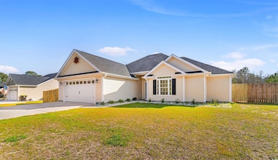 View of front of house featuring driveway, a garag