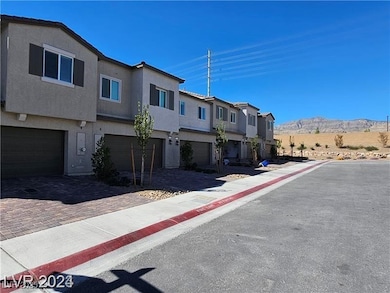 View of front of home with a residential view, stucco siding, a garage, and decorative driveway