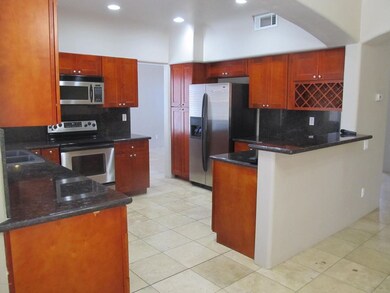 Kitchen with cherry cabs and granite