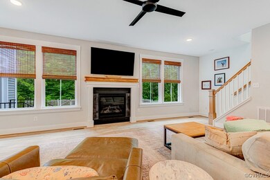 Living room featuring baseboards, a ceiling fan, w