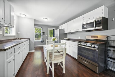 Kitchen featuring white cabinetry and stainless st