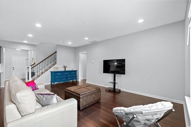 Living room with dark wood-type flooring