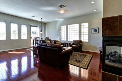 Living room featuring a multi sided fireplace, har