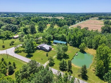 1.5 acres includes one level ranch home, large pond with dock and detached garage